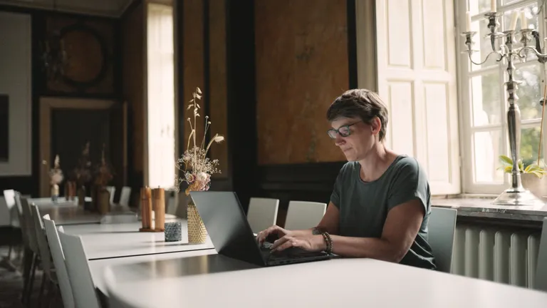 Event planner working on laptop at event venue