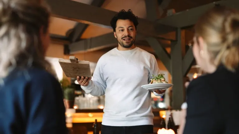 Floor manager serving food at event venue Vergulden Eenhoorn Amsterdam